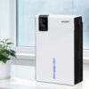 Devanti 2000Ml Portable Dehumidifier Operating On A Bedroom Bedside Table.