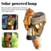 Retro Squirrel Lantern Solar Outdoor Wall Light Hanging Illuminated At Night On A Timber Garden Fence