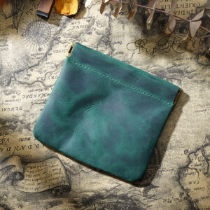 Dark green genuine leather coin purse with vintage squeeze closure on clean white background